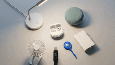 Smart gadgets under 30 dollars including earbuds, mini smart speaker, LED desk lamp, fitness tracker, and portable tech accessories arranged on a clean background.