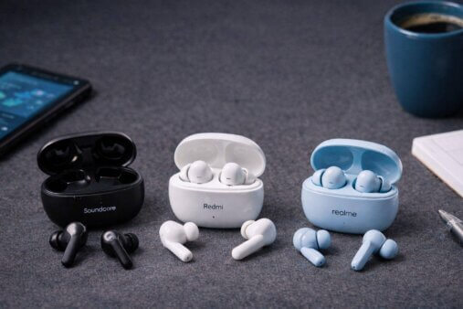 Budget wireless earbuds placed on a desk for everyday use